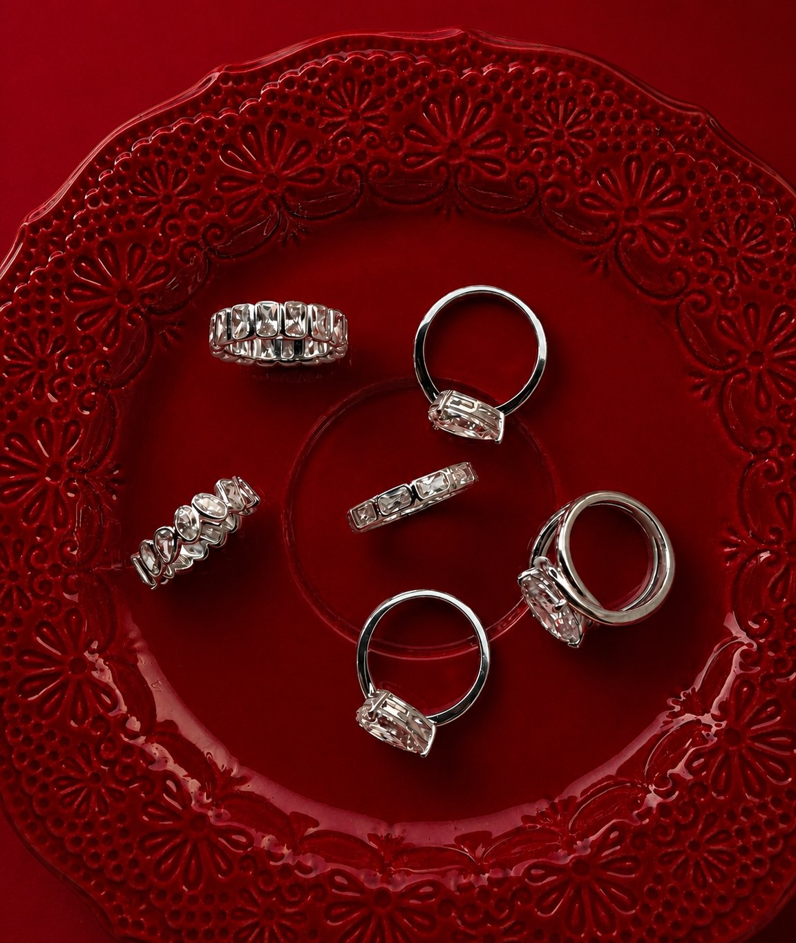 Diamond rings arranged on a red decorative plate